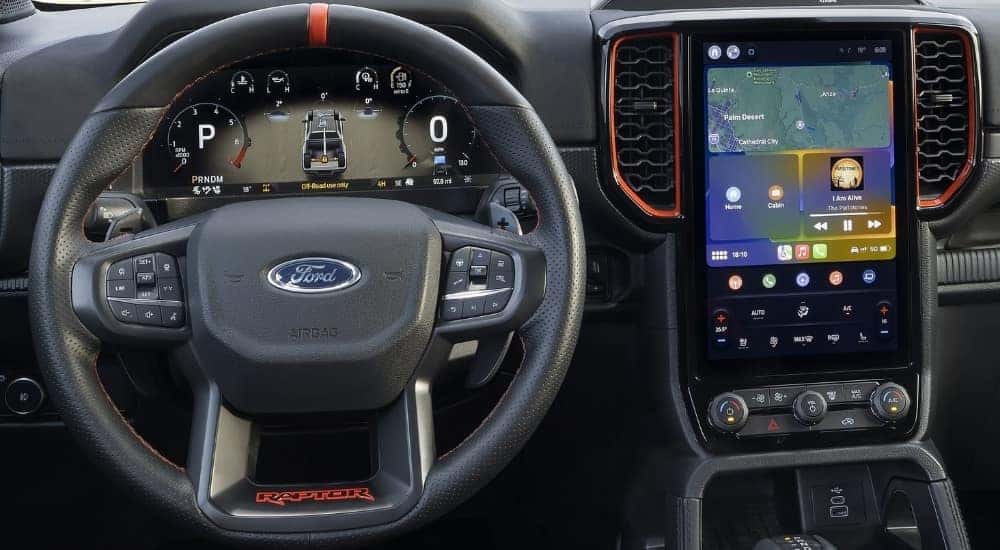 Close-up of the steering wheel and infotainment screen in a 2025 Ford Ranger Raptor.