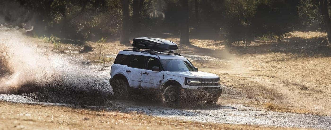 A white 2025 Ford Bronco Sport Big Bend is shown driving on mud.