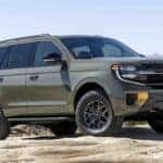 A green 2025 Ford Expedition Tremor parked off-road.