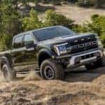 A black 2025 Ford F-150 Raptor off-roading.