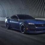 A blue 2025 Ford Mustang Dark Horse driving through a tunnel.