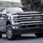 Grey 2025 Ford F-350 Platinum driving on a winding road