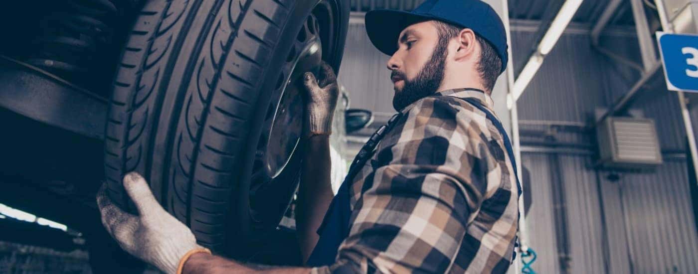 A mechanic is changing a tire at a Ford service center.