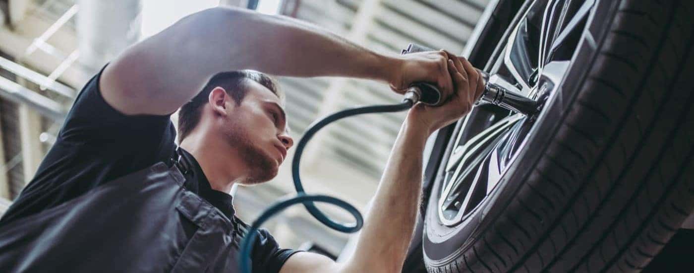 A mechanic is installing a wheel at a Ford service center near Marietta.