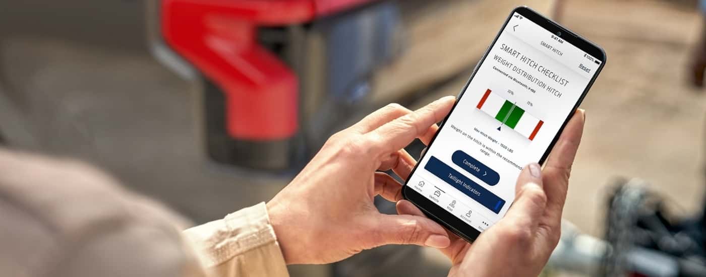 Person using smart phone near a 2025 Ford F-150 Lightning.