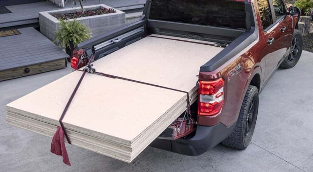 Wood in the bed of a red 2025 Ford Maverick.