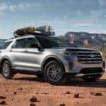A silver 2025 Ford Explorer Active parked off-road.