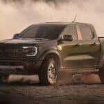 A black 2026 Ford Ranger Raptor off-roading in dirt