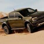 A green 2025 Ford Ranger Raptor off-roading.