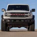 Front of a white 2026 Ford Bronco 60th Anniversary Edition parked off-road.
