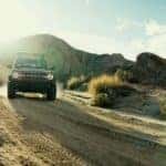 A red 2026 Ford Bronco off-roading.