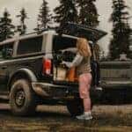Black 2026 Ford Bronco with a woman loading the trunk