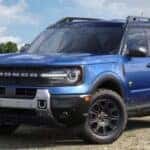 Blue 2026 Ford Bronco parked in a field