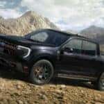 Black 2026 Ford Maverick Tremor driving up a rocky mountainside