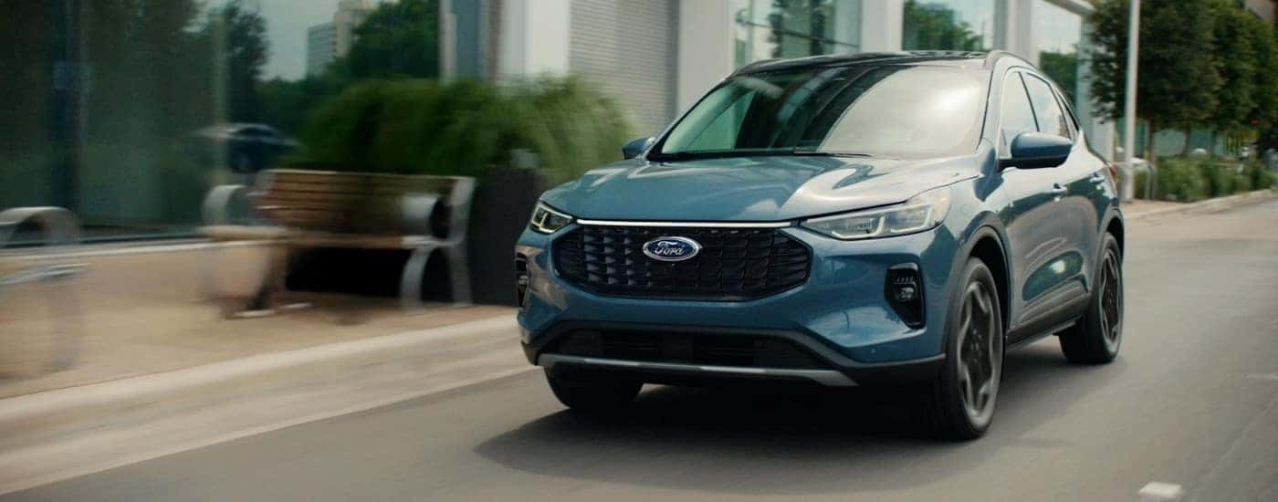 Blue 2026 Ford Escape driving on a city street