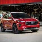 Red 2026 Ford Escape parked in front of a store.