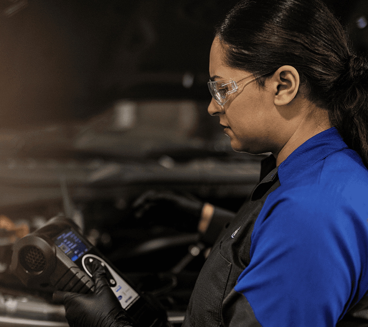 technician holding a diagnostic tool