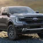 A grey 2024 Ford Ranger XLT parked on gravel.