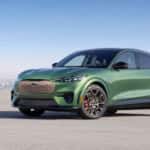 A green 2025 Ford Mustang Mach-E GT is shown from the front at an angle.