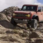 A red 2025 Ford Bronco Raptor is shown from the front at an angle after receiving auto repair near Snellville.