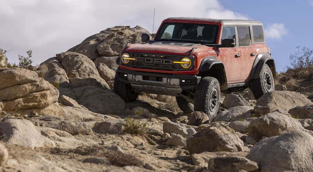 A red 2025 Ford Bronco Raptor is shown from the front at an angle after receiving auto repair near Snellville.