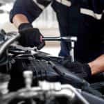 A mechanic working on a car engine at an auto repair shop near Grayson.