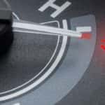 A close up of the temperature gauge on a vehicle that needs a radiator repair.