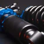 A close up of a vehicle's new struts during a replacement.