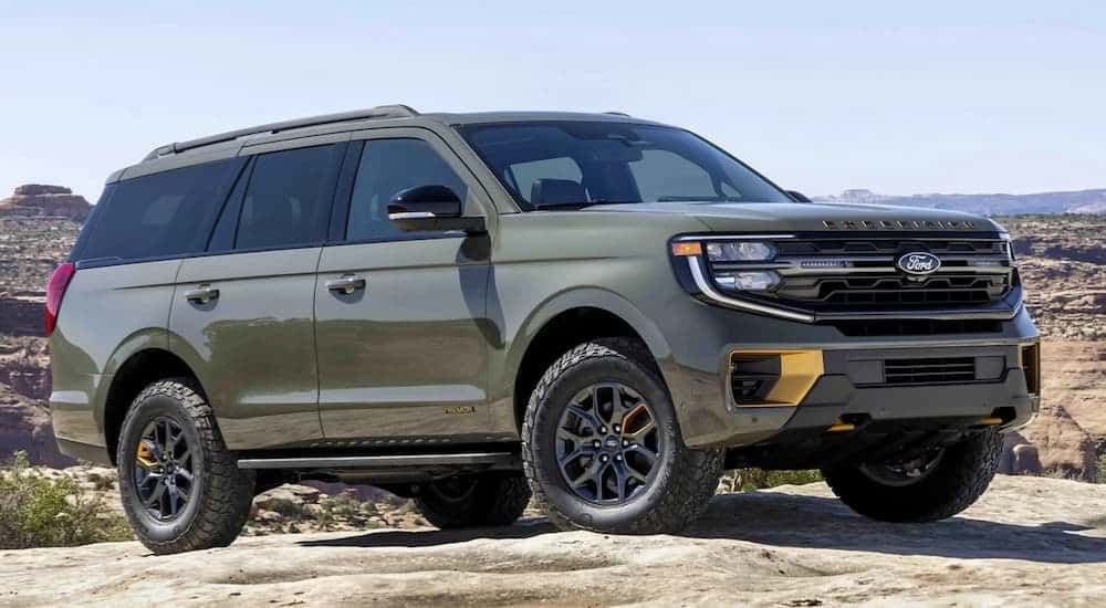 A green 2025 Ford Expedition parked off-road.