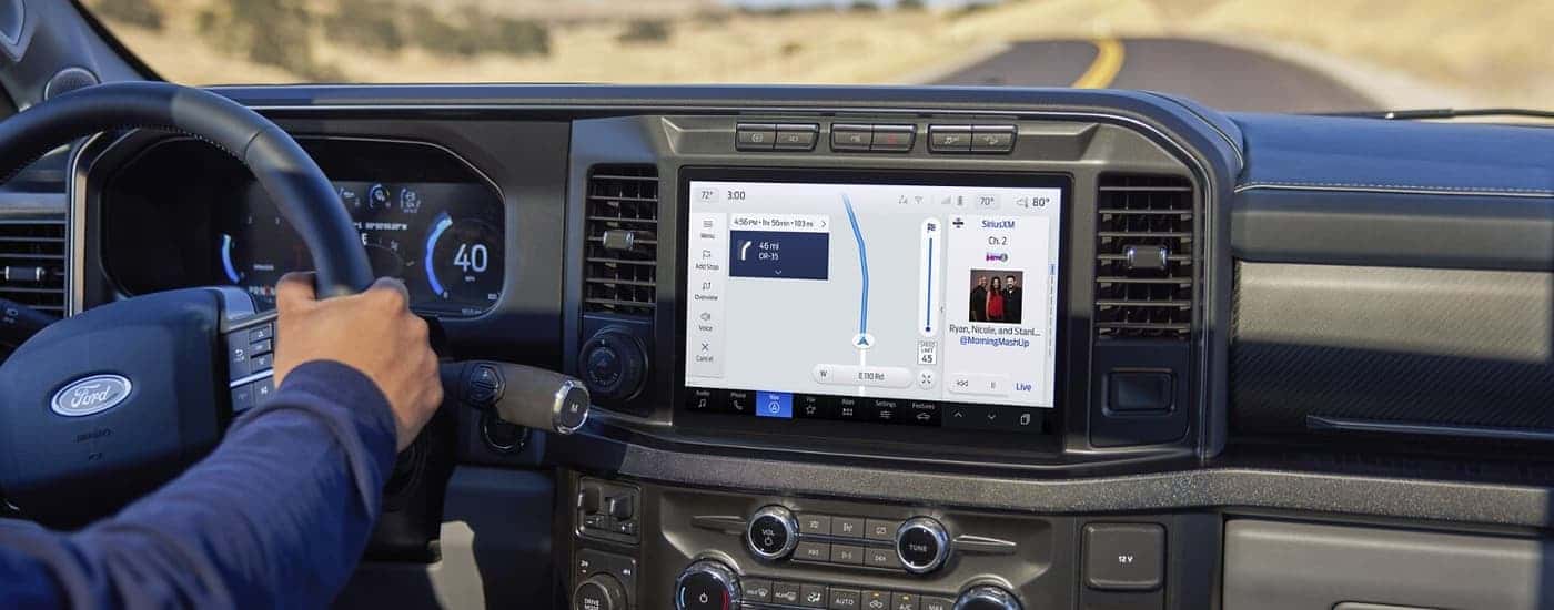 A man using the map screen on the infotainment center in a 2025 Ford F-350.