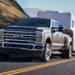 A grey 2025 Ford F-350 towing a trailer.