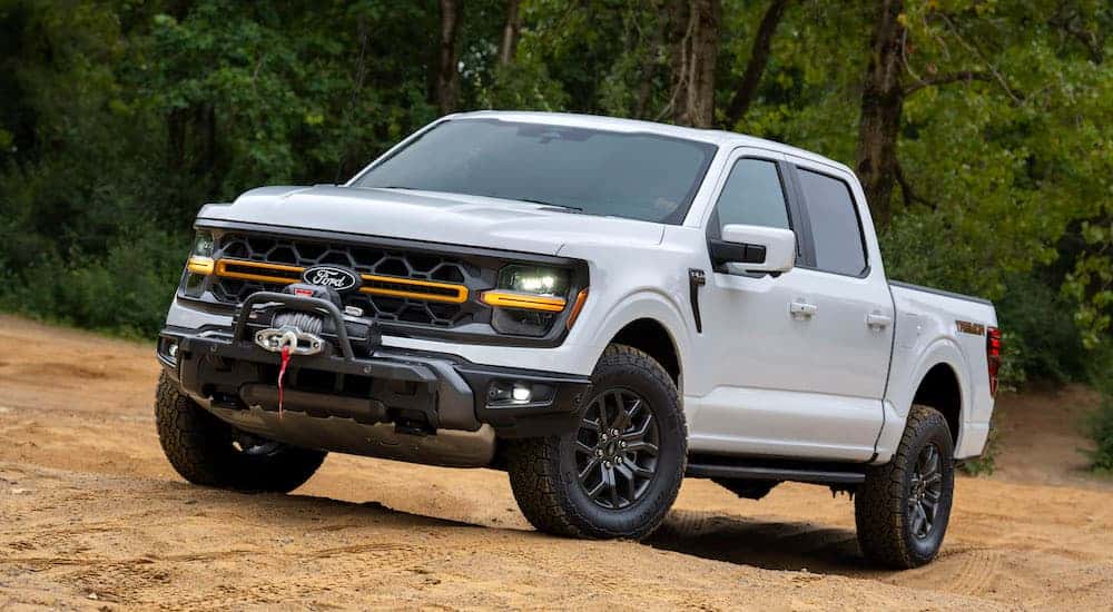 A white 2025 Ford F-150 for sale near Conyers from the front at an angle.
