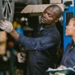 Two technicians evaluating a tire at a tire shop near Conyers.