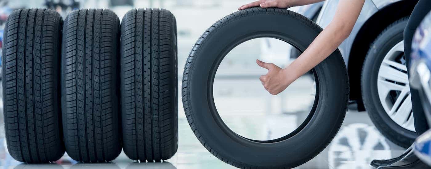A mechanic selecting tires.