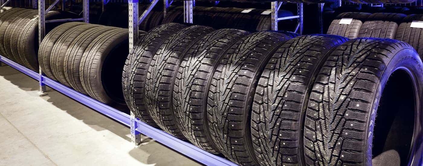 A line of tires on a rack.