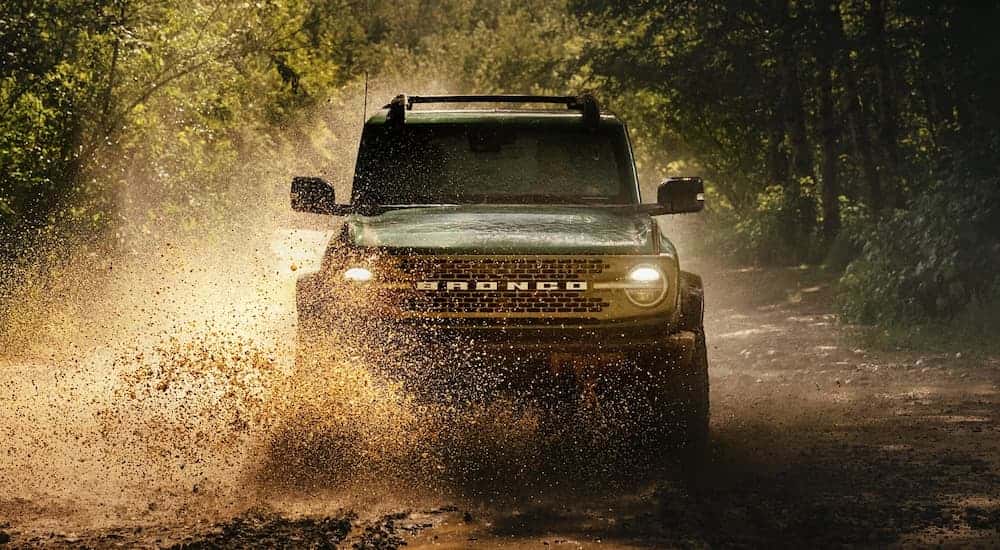 A 2025 Ford Bronco off-roading in mud