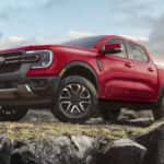 A red 2025 Ford Ranger Lariat parked off-road.