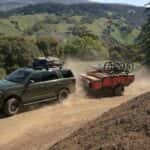 A green 2024 Ford Expedition Timberline driving on a trail.