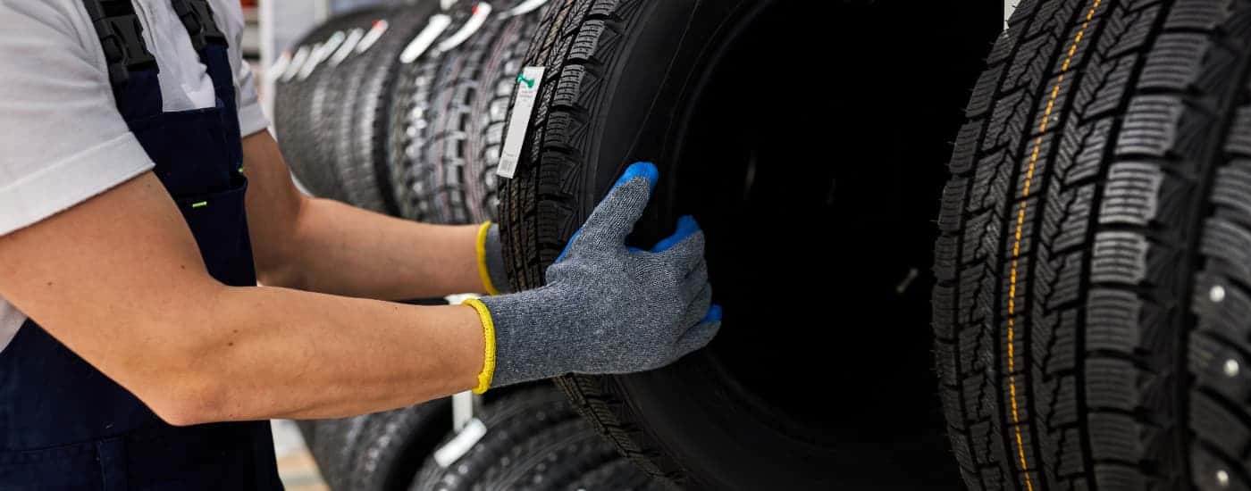 An automotive technician choosing the right size tire