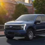 A blue 2025 ford F-150 Lightning from the front at an angle.