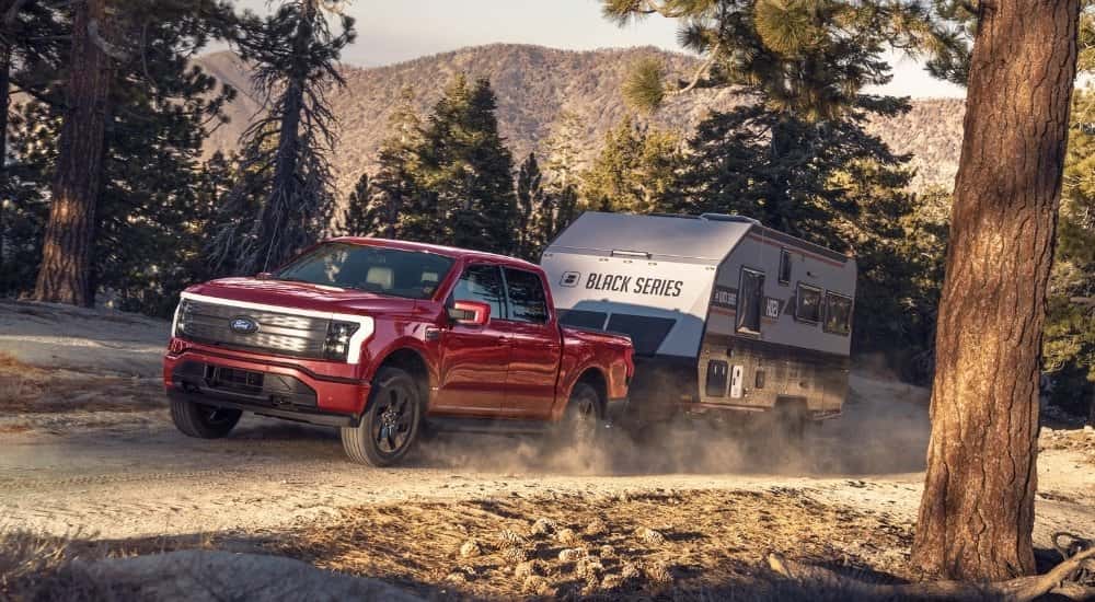 A red 2025 Ford F-150 Lighting from the front at an angle.