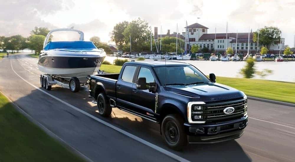 A blue 2025 Ford F-350 Super Duty towing a boat.