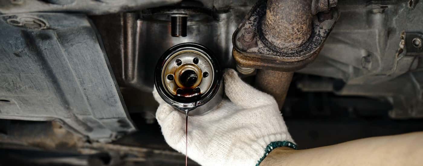 A technician holding a used oil filter.
