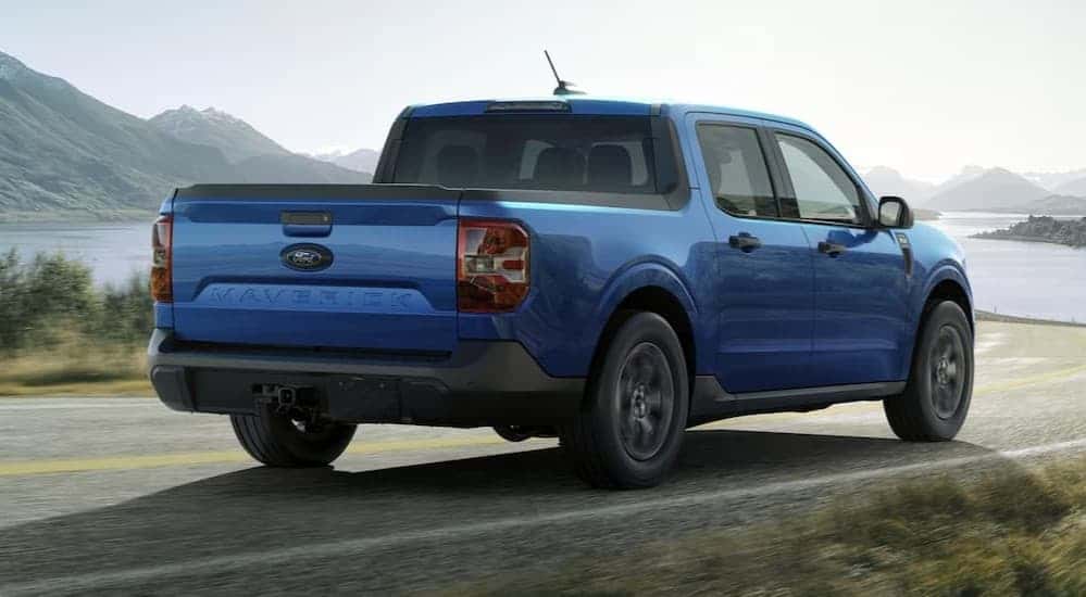 A blue 2025 Ford Maverick driving on a highway.