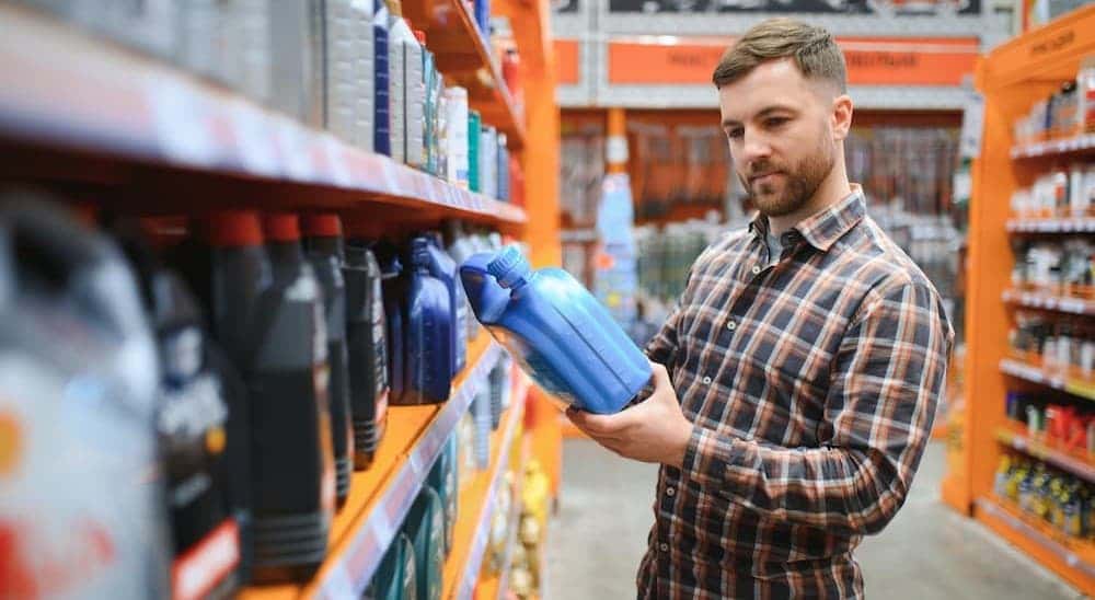A person holding an oil container.