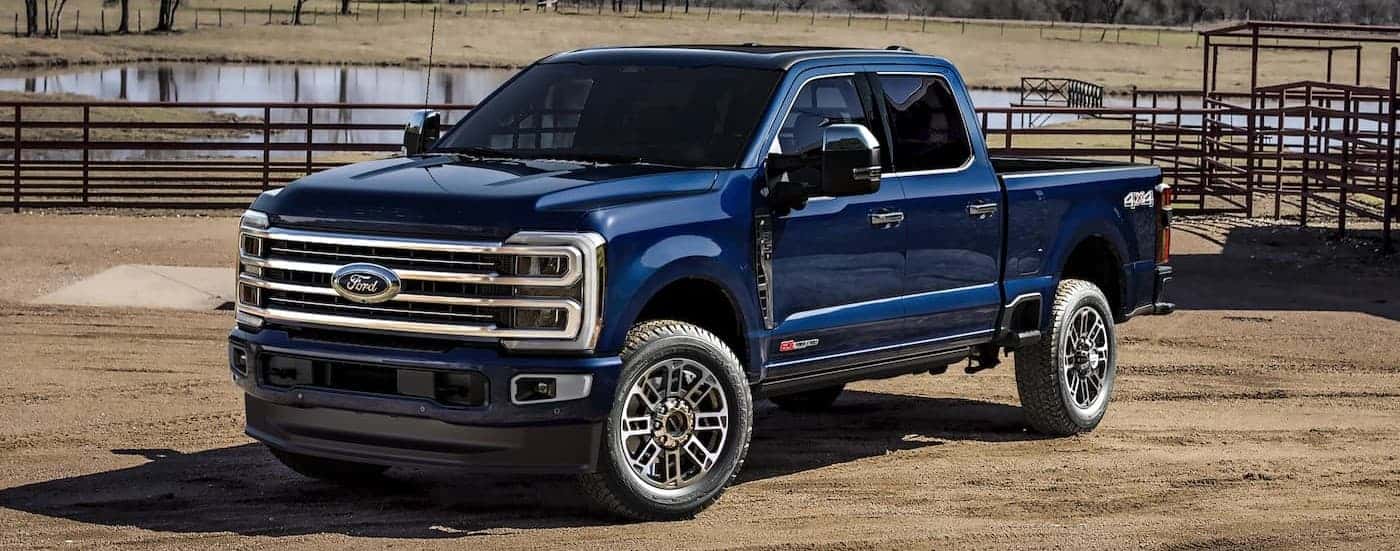A blue 2025 Ford F-250 parked off-road.