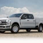 A white 2025 Ford F-250 parked near a field.