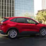 Red 2025 Ford Escape Active for sale near Monroe driving past buildings