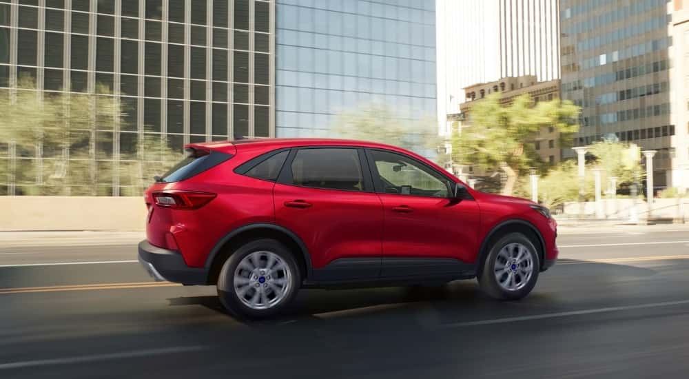 Red 2025 Ford Escape Active for sale near Monroe driving past buildings
