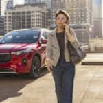 Person walking past a red 2025 Ford Escape